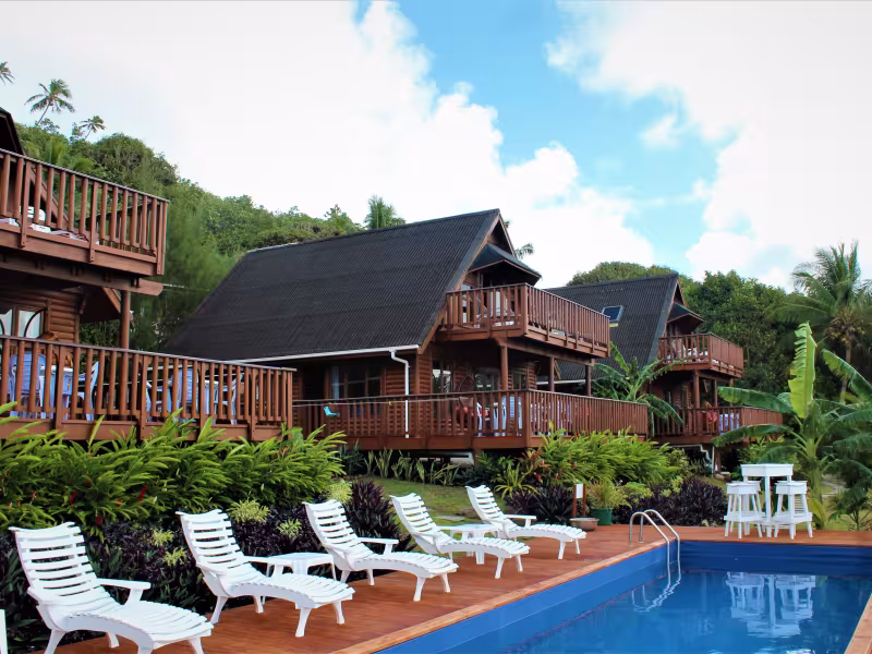 Exterior view of 3 villas. Pool lounging area. 