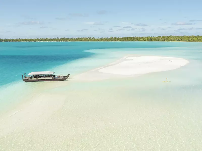 Aitutaki Lagoon with Vaka cruise boat by sandbank
