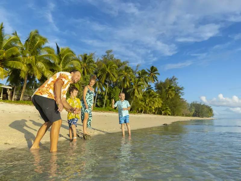 Family on the beach skipping stones