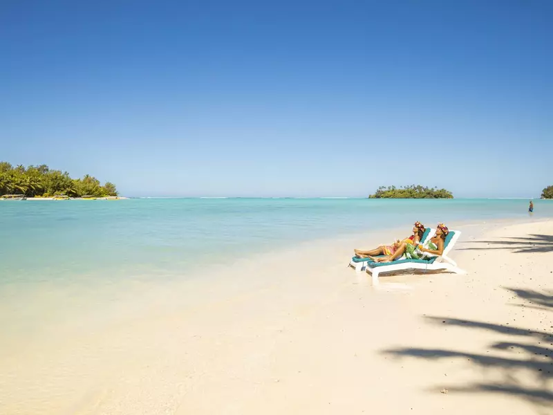 Girls lay on sun lounges on the beach 