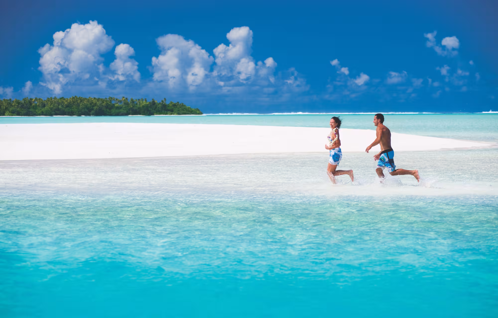 Couple running through the water