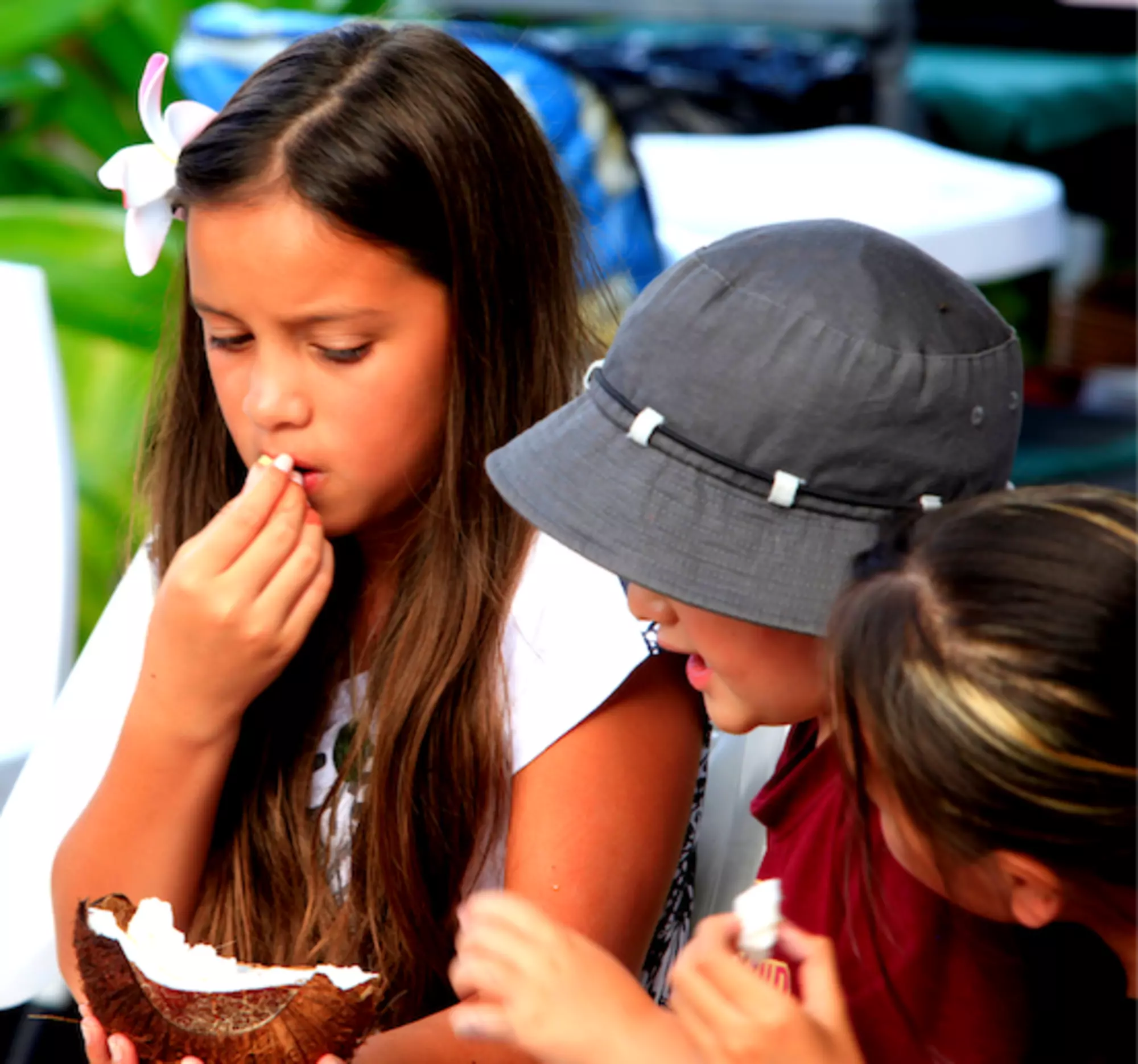 Child eating coconut at The Brasserie Restaurant at Edgewater Resort & Spa