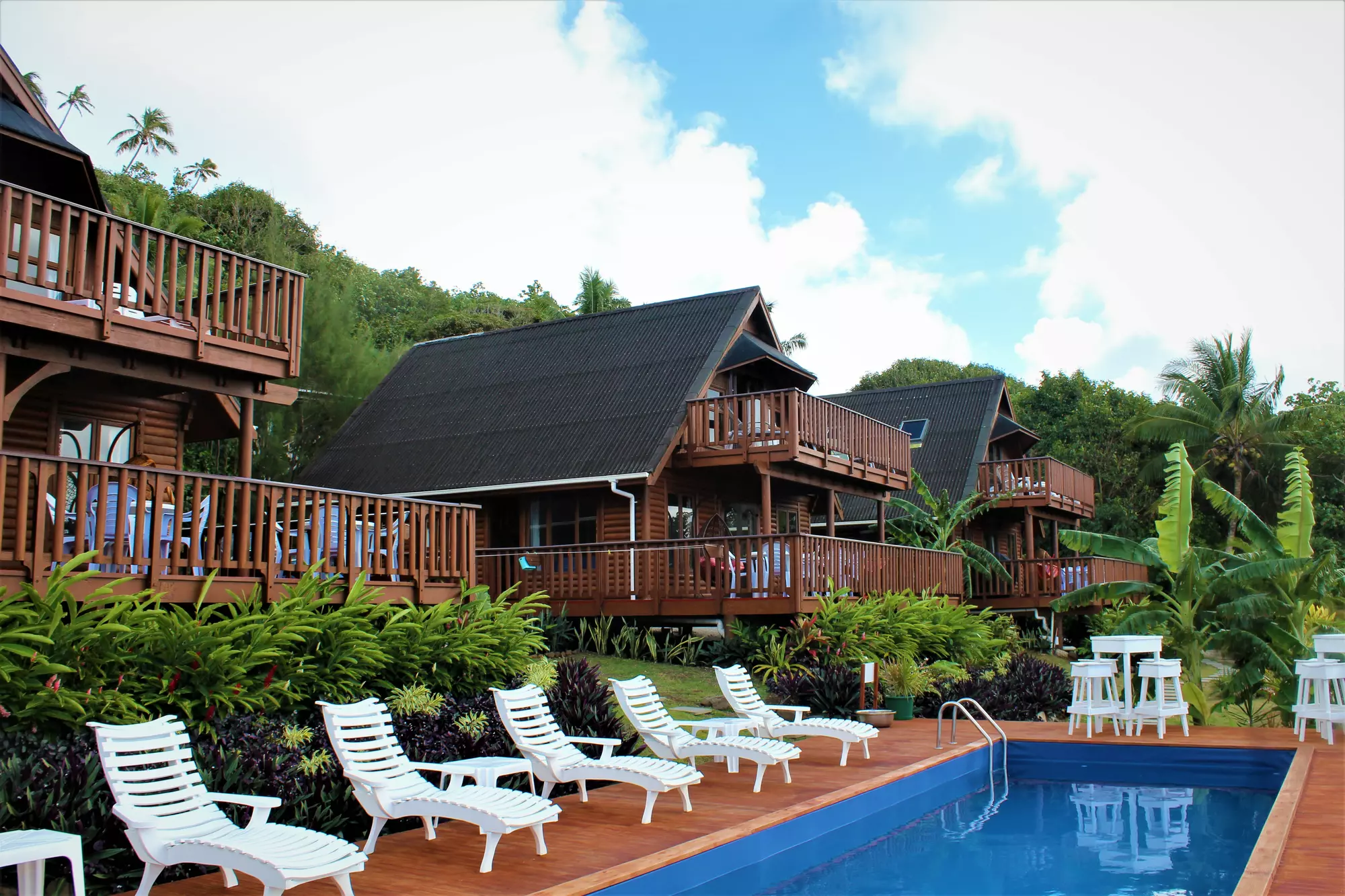 Exterior view of 3 villas. Pool lounging area. 
