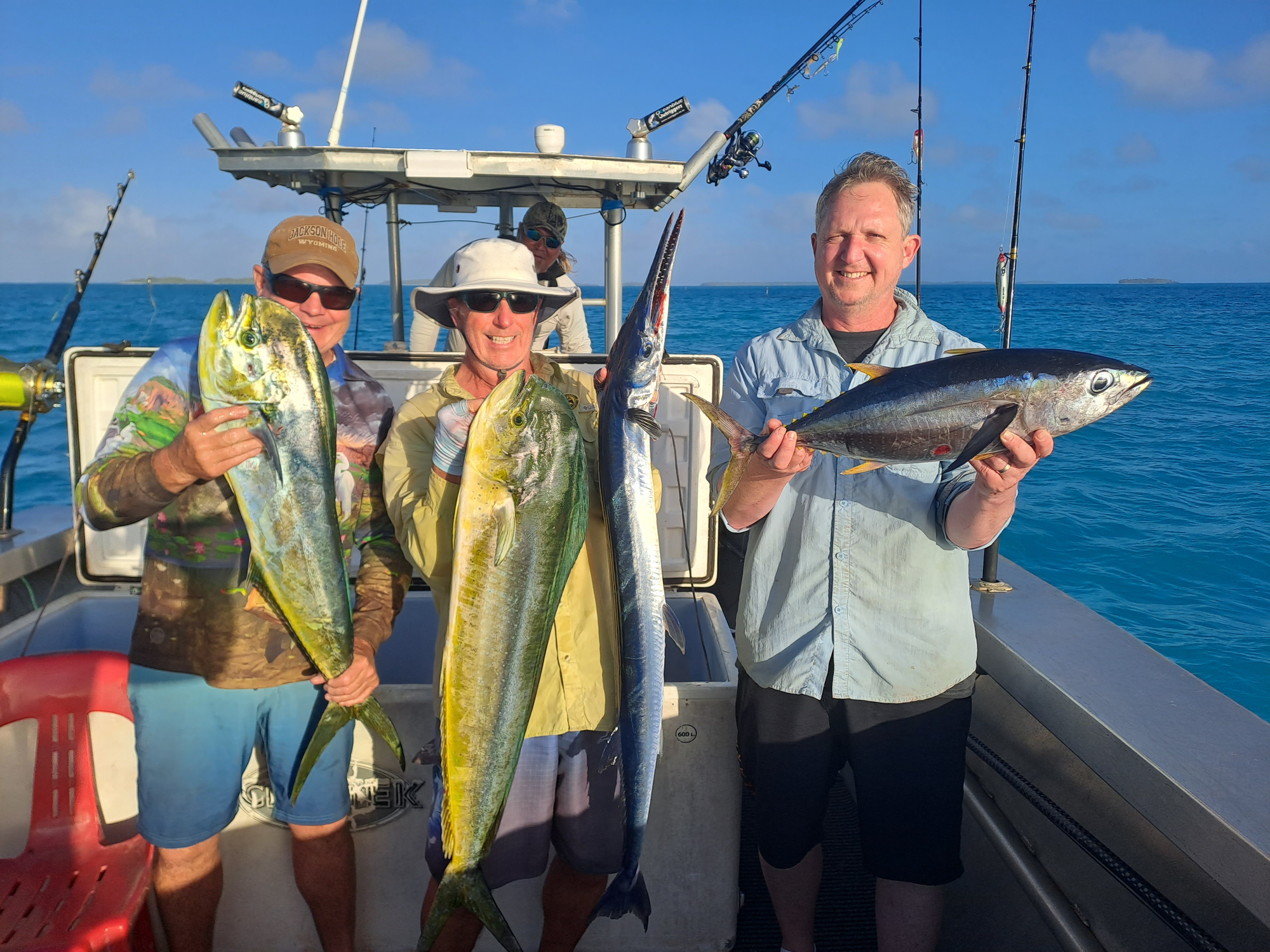 Men hold fish on boat 