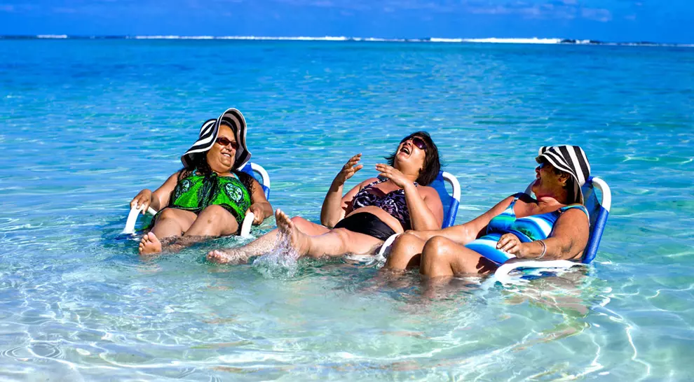Ladies Laughing while sitting in beach chairs in the lagoon
