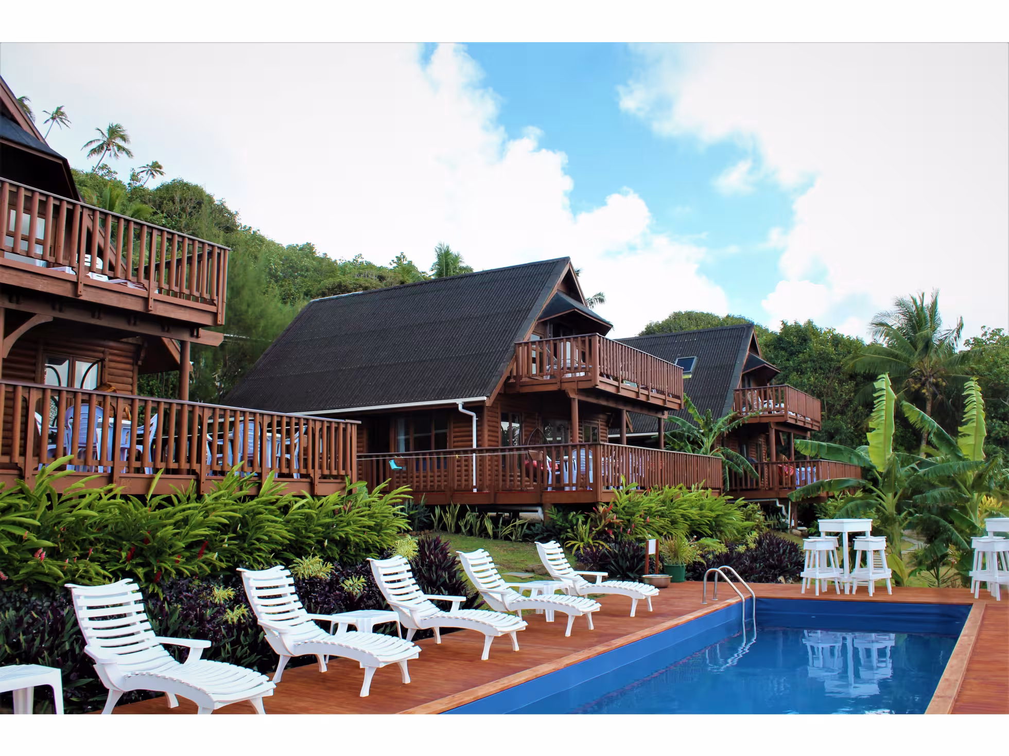 Exterior view of 3 villas. Pool lounging area. 