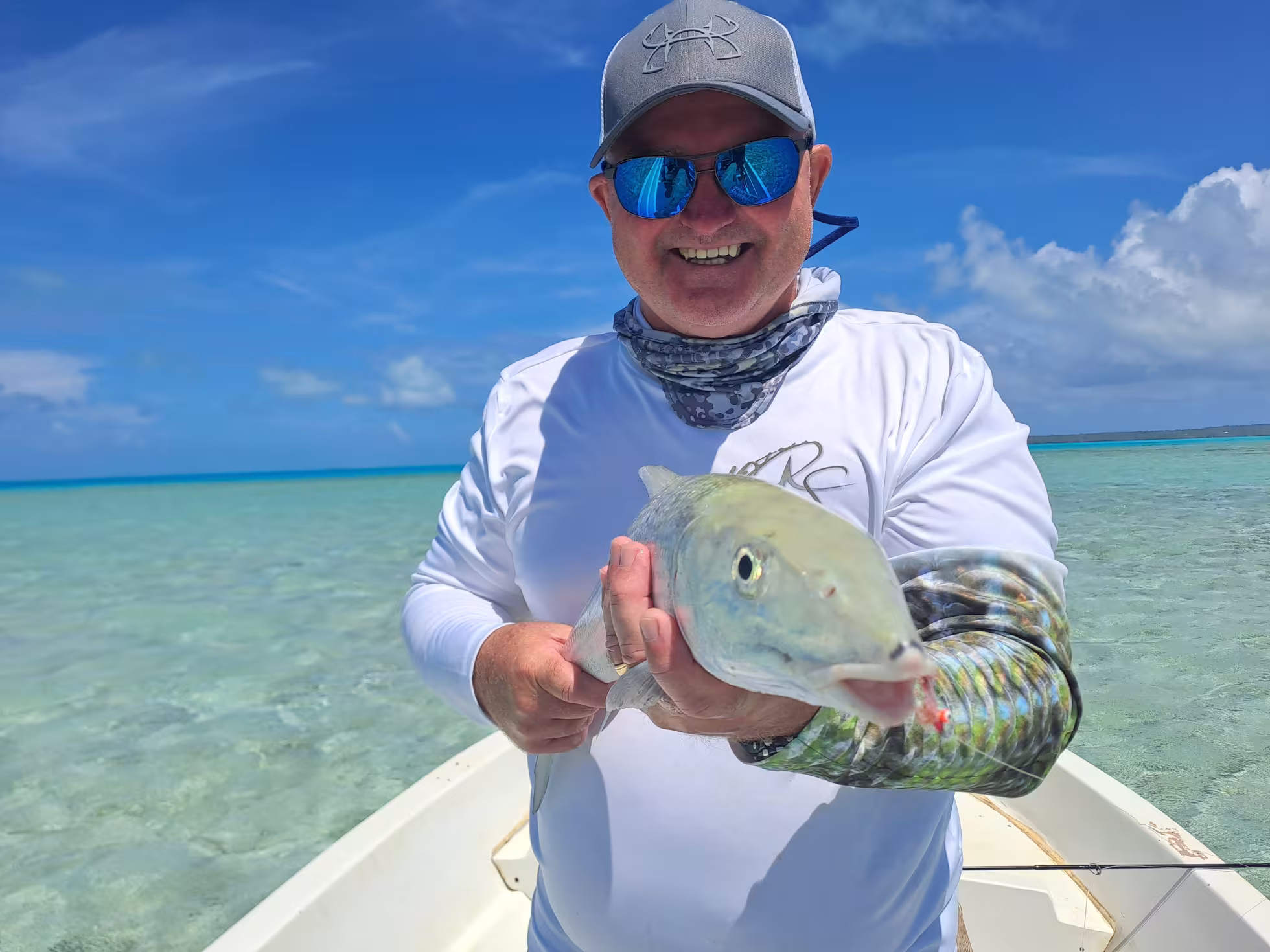Bonefish charter - fisherman holding catch