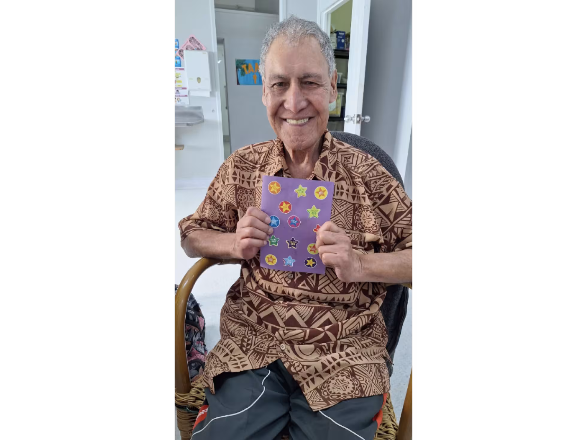 A Creative centre client holding his art
